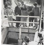 Dedication ceremony at Oat Hills Tunnel, releasing water into the San Diego Aqueduct. Left to Right: Chairman Fred A. Heilbron, Water Authority; D.E. Howell, San Diego County; E.G. Nielsen, Bureau of Reclamation; Chairman Joseph Jensen, Metropolitan Water District; Capt. C.W. Porter, U.S. Navy. Extreme left: General Manager and Chief Engineer Richard S. Holmgren observing removal of bulkhead. Photo: SDCWA Archives