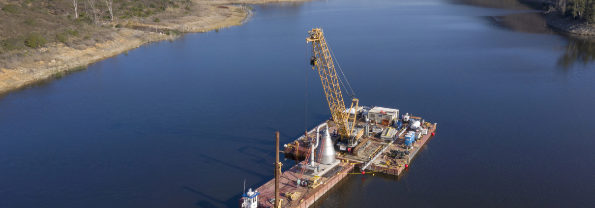 Crews loaded the 130,000 pound stainless steel cone onto a barge and finished assembling it above water before lowering it into the reservoir. Image: Water Authority