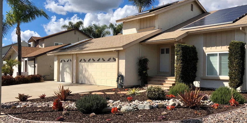 Vibrant pink, orange, purple and red succulents are interspersed among lush rosemary and lavender bushes in this award-winning landscape makeover in Santee. Photo: Padre Dam MWD