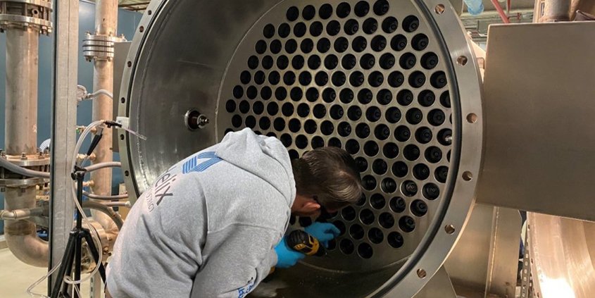 A Helix staff member installs parts in the ozone generator. Photo: Helix Water District